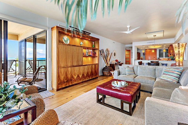 living room with ceiling fan and light hardwood / wood-style floors