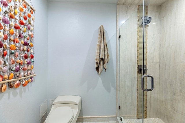 bathroom featuring walk in shower and toilet