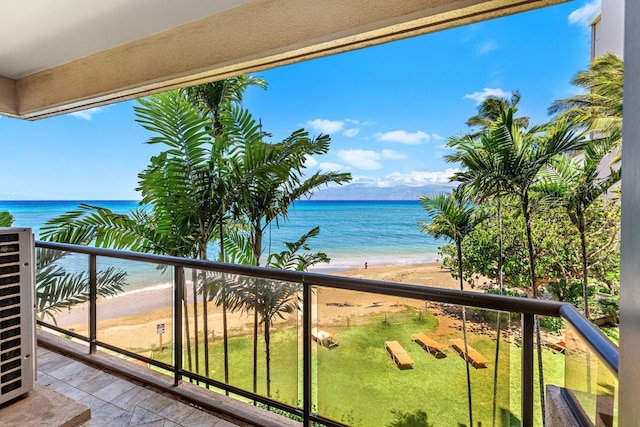 balcony featuring a water view and a beach view