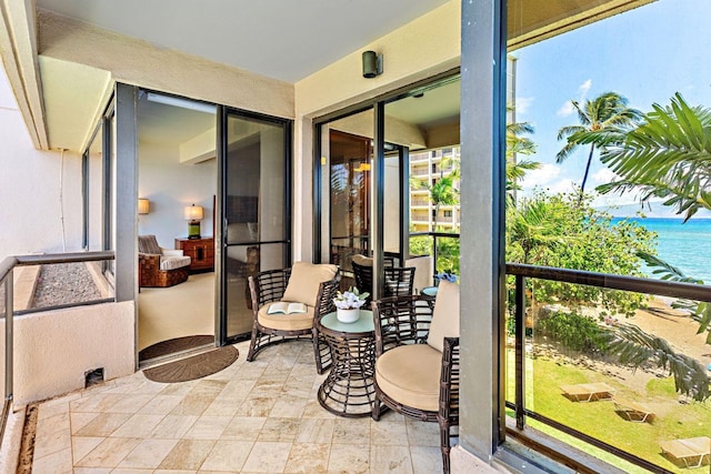 sunroom / solarium featuring a water view