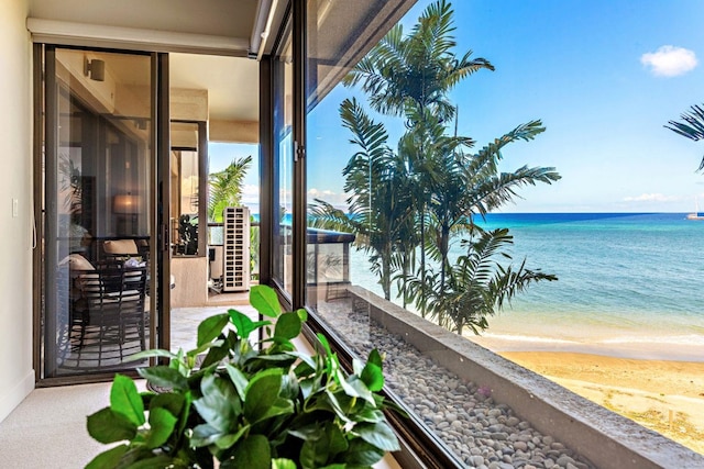 balcony with a beach view and a water view