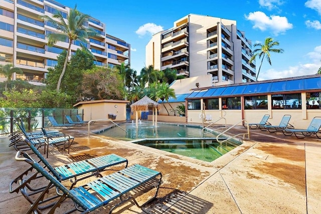 view of pool with pool water feature and a patio area