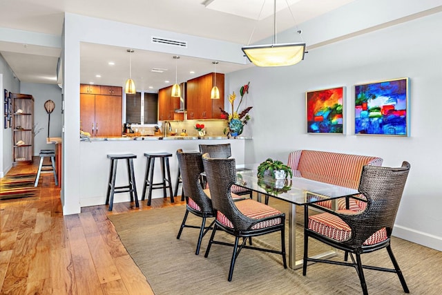 dining area with hardwood / wood-style floors