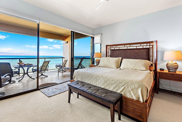 carpeted bedroom with a water view, ceiling fan, and access to exterior