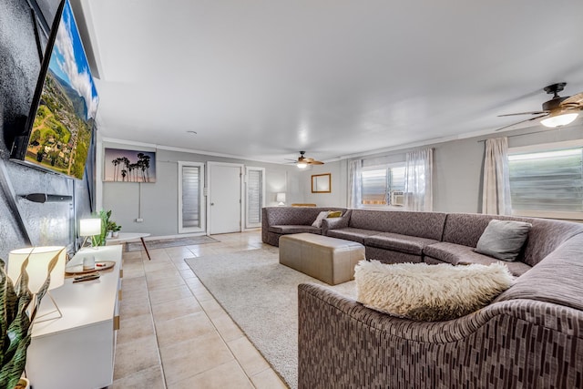 living room featuring a ceiling fan, ornamental molding, and light tile patterned floors