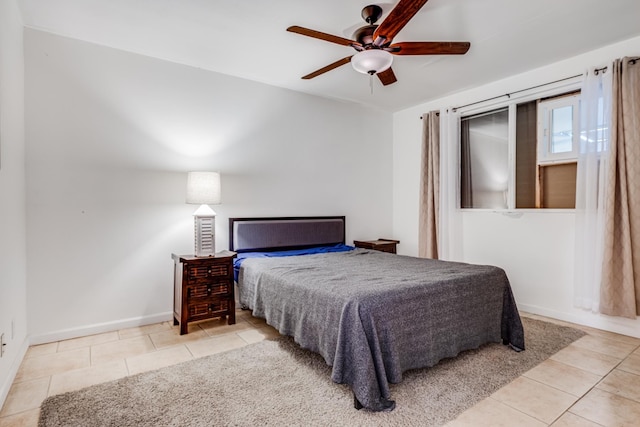 bedroom featuring baseboards, ceiling fan, and tile patterned floors