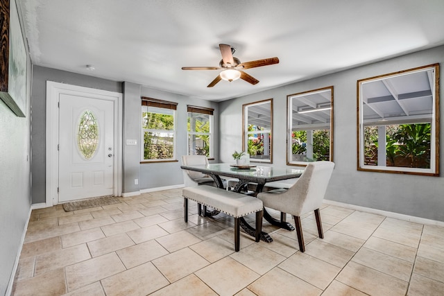 dining space with ceiling fan and light tile patterned flooring