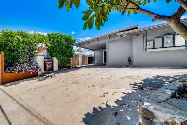 view of front of house with fence and stucco siding