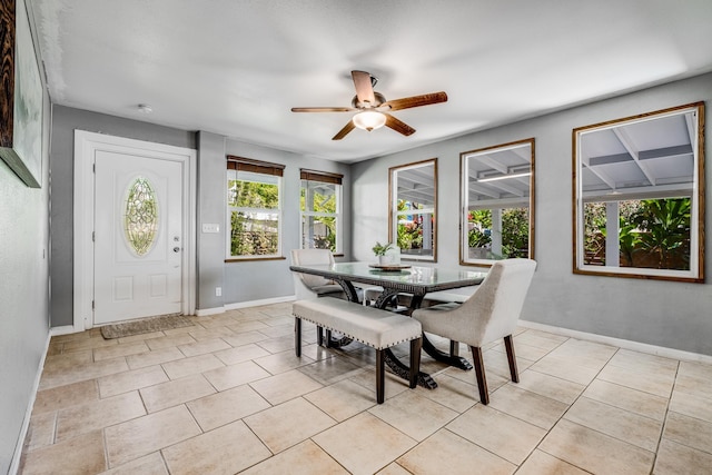 dining room featuring light tile patterned flooring, ceiling fan, and baseboards