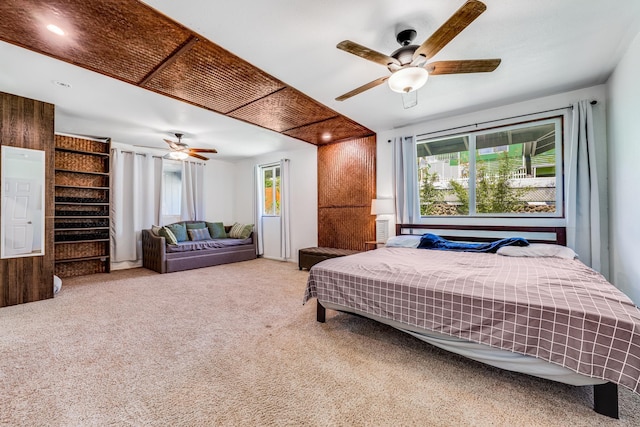 carpeted bedroom with multiple windows and ceiling fan