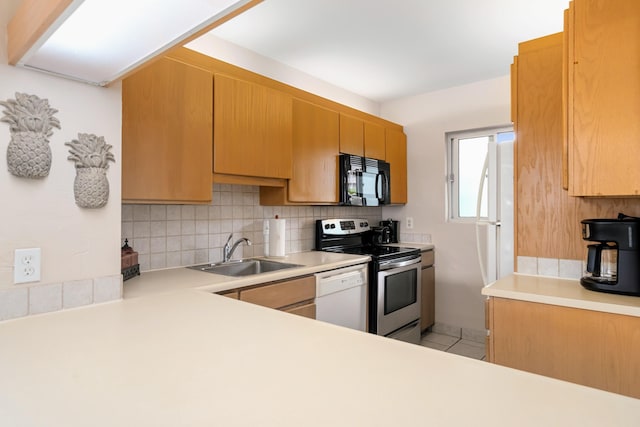 kitchen with stainless steel electric stove, decorative backsplash, sink, and white dishwasher