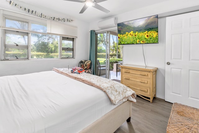 bedroom with an AC wall unit, multiple windows, ceiling fan, and hardwood / wood-style floors