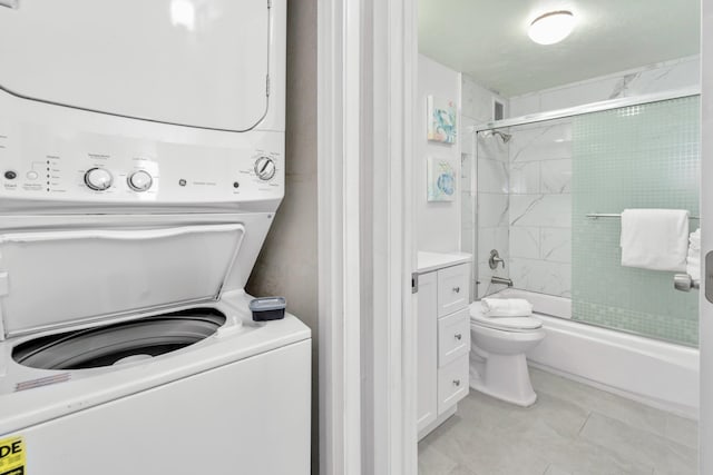 laundry room with stacked washer and dryer and light tile patterned floors