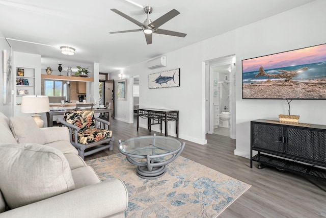 living room featuring an AC wall unit, ceiling fan, and wood-type flooring