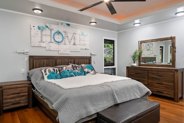 bedroom featuring ornamental molding, ceiling fan, and wood finished floors