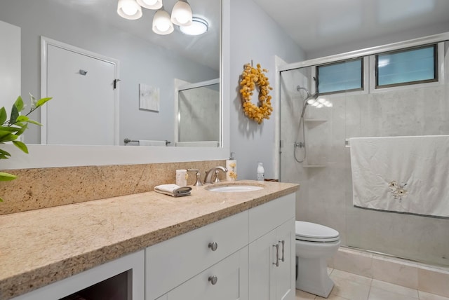full bathroom with toilet, a stall shower, tile patterned floors, and vanity