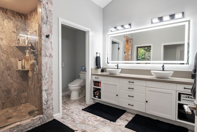 bathroom with marble finish floor, a sink, and a stall shower