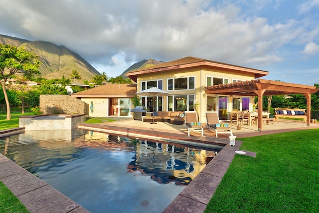 rear view of house featuring outdoor lounge area, a yard, a pergola, and a patio