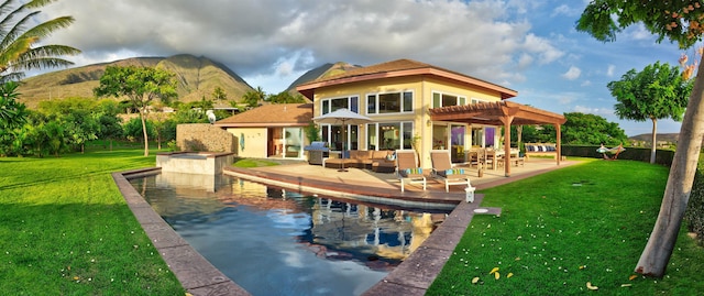 back of property featuring a yard, a patio area, a pergola, and outdoor lounge area