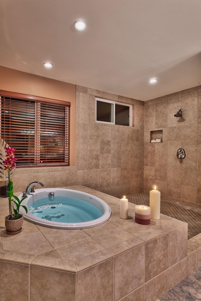 bathroom featuring shower with separate bathtub