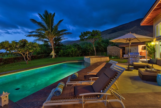 view of pool with a yard, a mountain view, an outdoor living space, area for grilling, and a patio