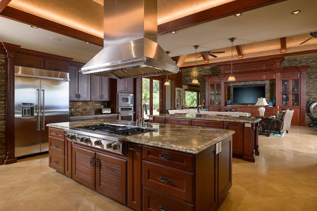 kitchen featuring built in appliances, a spacious island, island range hood, ceiling fan, and beam ceiling