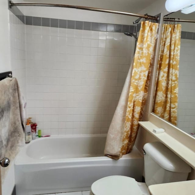 bathroom with shower / tub combo and toilet