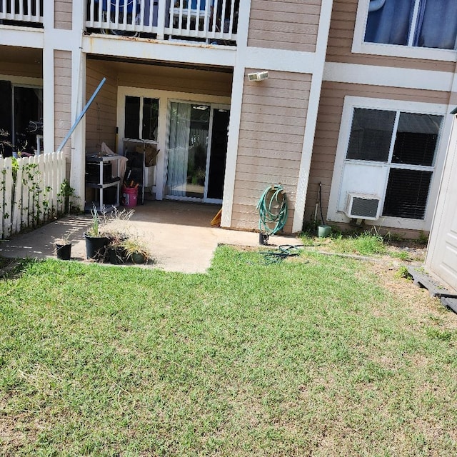 exterior space with a patio area, a lawn, and a balcony