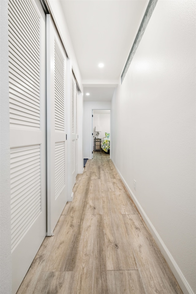 hall with light hardwood / wood-style floors