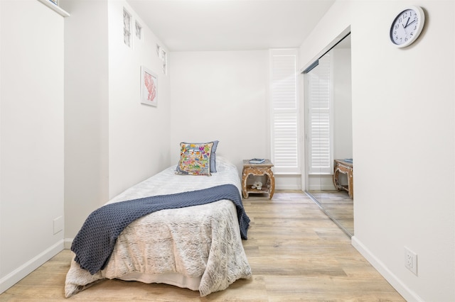 bedroom with a closet and wood-type flooring