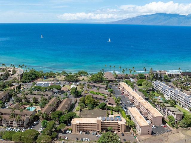 drone / aerial view featuring a water and mountain view