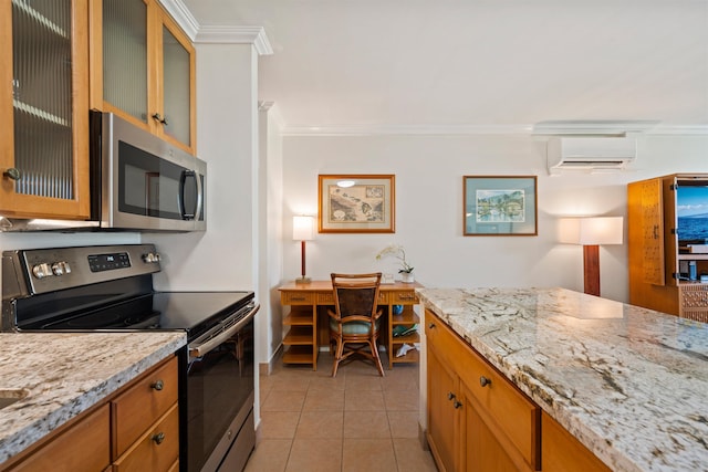 kitchen with light tile patterned floors, appliances with stainless steel finishes, light stone counters, ornamental molding, and an AC wall unit