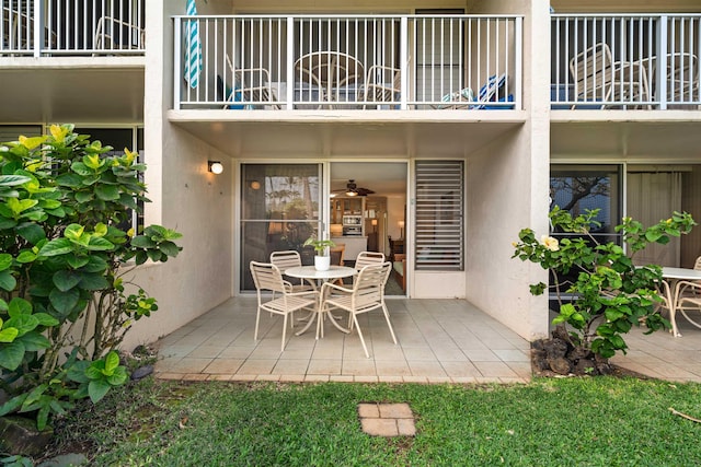 view of patio with outdoor dining area and a balcony