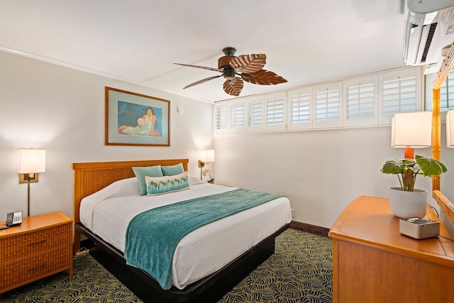 bedroom featuring a wall unit AC, ceiling fan, and baseboards