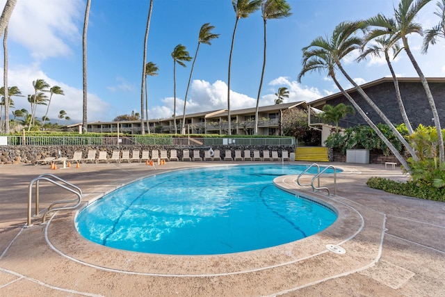 pool with fence and a patio