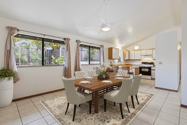 dining room featuring ceiling fan, vaulted ceiling, and light tile patterned flooring