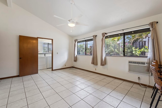 tiled empty room featuring washing machine and dryer, ceiling fan, and lofted ceiling