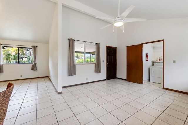 tiled empty room featuring high vaulted ceiling, washer / clothes dryer, and ceiling fan