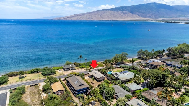 birds eye view of property with a water and mountain view