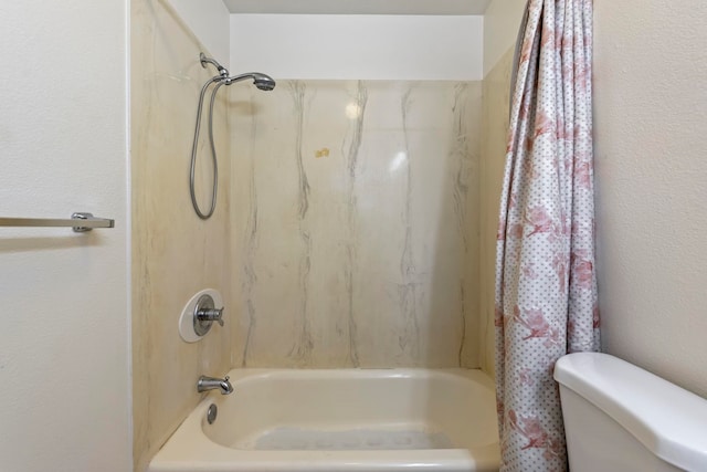 bathroom with toilet and shower / bath combo with shower curtain