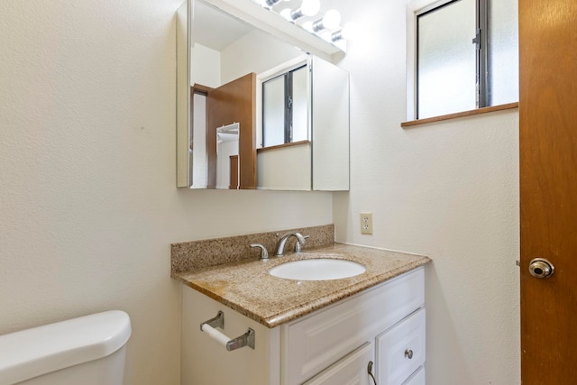 bathroom with toilet and vanity