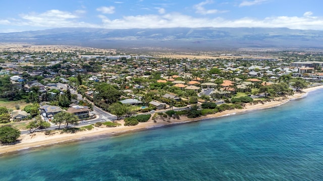 bird's eye view featuring a water view and a beach view