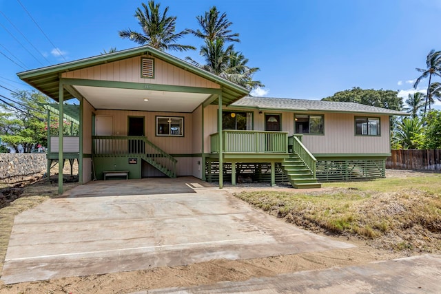 view of front of property featuring a carport and a porch