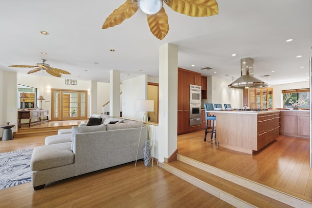 563 Mikioi Pl, Kihei, HI 96753 - living room featuring ceiling fan, light wood-type flooring, recessed lighting, and stairway