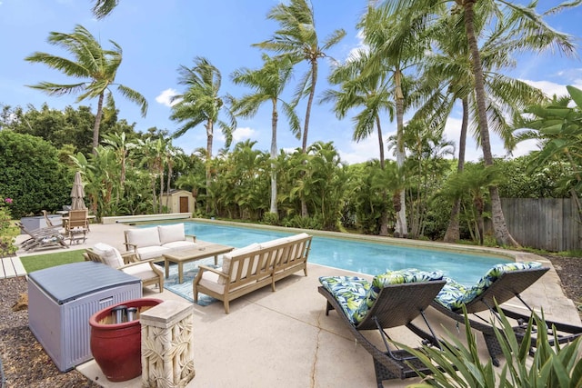 563 Mikioi Pl, Kihei, HI 96753 - view of swimming pool with a storage shed, a patio area, an outdoor hangout area, and view of wooded area