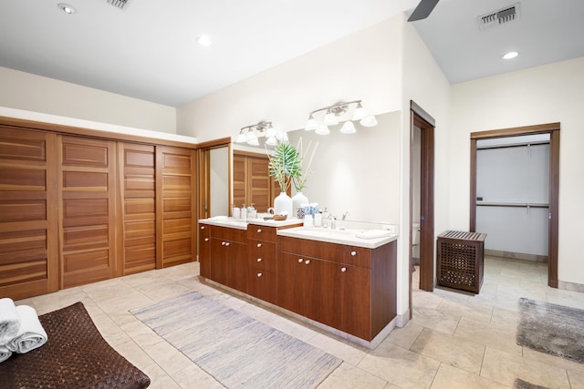 563 Mikioi Pl, Kihei, HI 96753 - bathroom with a closet, double vanity, tile patterned flooring, and recessed lighting