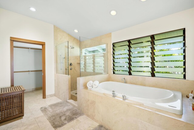 563 Mikioi Pl, Kihei, HI 96753 - full bathroom featuring a bath, walk in shower, tile patterned flooring, recessed lighting, and a spacious closet
