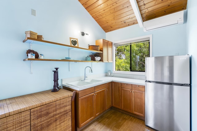563 Mikioi Pl, Kihei, HI 96753 - kitchen with freestanding refrigerator, open shelves, an AC wall unit, lofted ceiling, and wood finished floors
