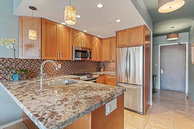 kitchen with kitchen peninsula, pendant lighting, stainless steel appliances, and sink