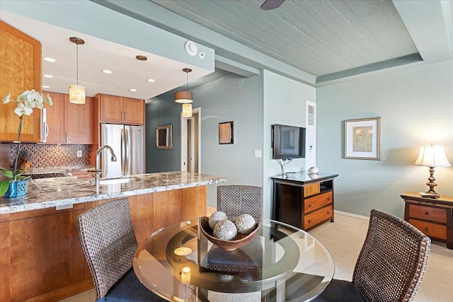 dining space with light colored carpet and sink